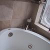 Porcelain tiles, jacuzzi tub and roman tub faucet installed
