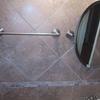 Brushed nickle towel bars and mirror on porcelain tile