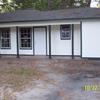 Front of home after garage conversion to den, complete hardi siding, new windows and porch supports.